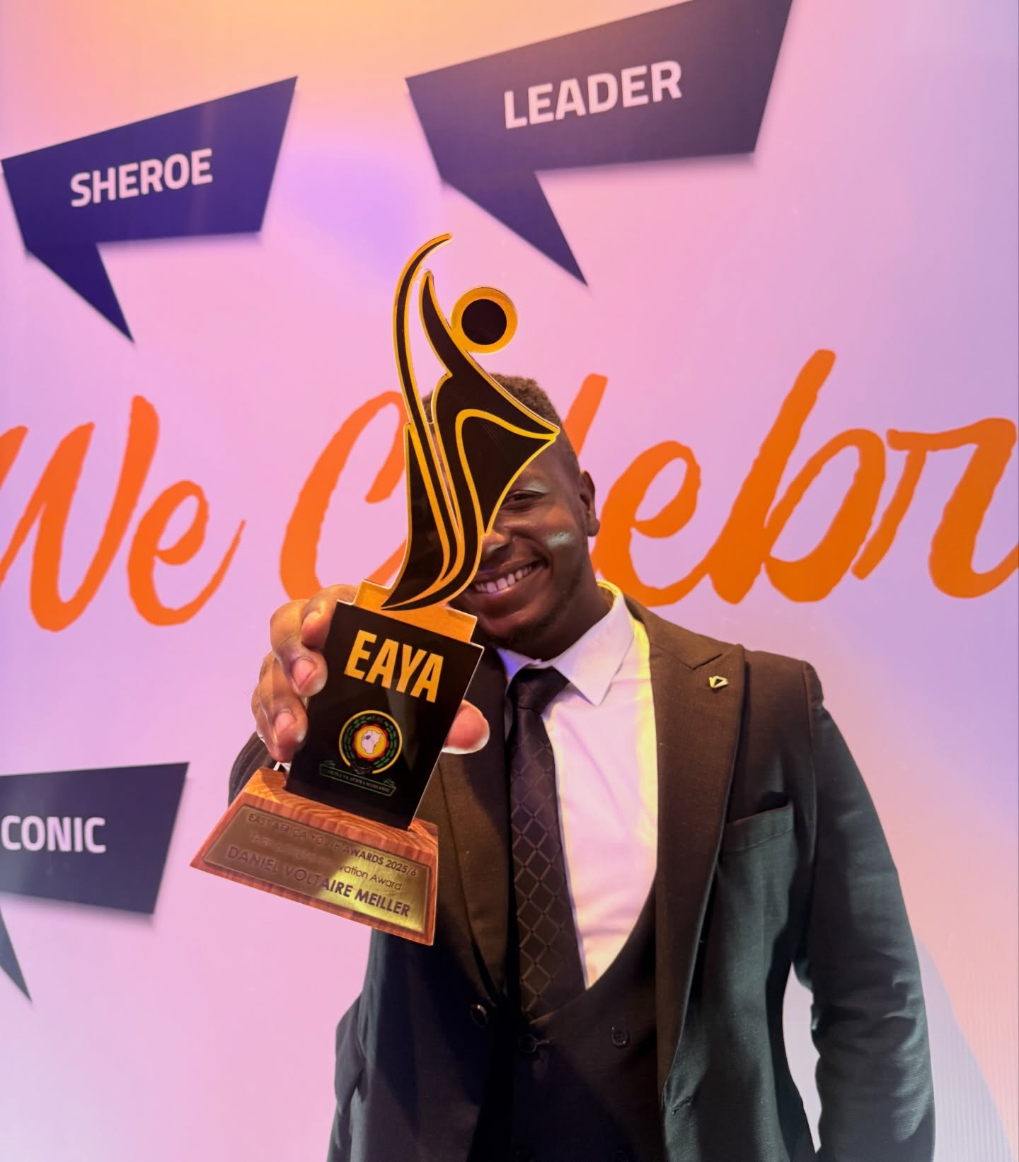 Holding the East Africa Youth Award trophy